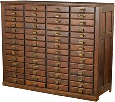 an old wooden cabinet with many drawers and brass knobs on the doors, isolated against a white background