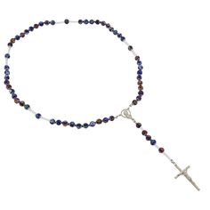 This Murano Glass Rosary Necklace features beautiful blue Millefiori beads and a silver-plated crucifix handcrafted by the skilled master glass-makers in a family-owned workshop on Murano island in Venice, Italy. The rosary necklace is created by hand using ancient glass-making tools and techniques. This is a beautiful religious gift with an Italian flair that will be uniquely appropriate for a special occasion. Measurements: Full Length is 27 inches. The length from the centerpiece to the botto Blue Crucifix Necklace For Spiritual Purposes, Blue Cross Jewelry With 8mm Beads, Blue Crucifix Necklace For Spiritual Wear, Handmade Blue Crucifix Jewelry, Adjustable Murano Glass Necklace, Venice Glass, Adjustable Gold Murano Glass Necklaces, Blue Cross-shaped Jewelry With 8mm Beads, Millefiori Beads