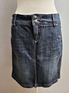 "Vintage medium dark blue jean skirt. Denim knee length cotton skirt. Size 36 EU. Germany women`s clothing. Frontal pleated decorative split.  Frontal zipper and 2 metal buttons. 2 sides pockets. The pockets on the back, only decorative. The loops for the belt. This jeans skirt is perfect for summer, autumn fall and spring.  labeled material: 69% cotton, 30% polyester, 1% spandex. Machine wash in 30 C inside out.  Condition: great used vintage. No damages or holes. Measurements in lying flat: le Cheap Dark Wash Denim Mini Skirt, Cheap Dark Wash Mini Skirt With Pockets, Dark Wash Cotton Denim Skirt With Button Zip Fly, Germany Women, Denim Skirts Knee Length, Cotton Skirts, Blue Jean Skirt, Skirt Denim, Jeans Skirt