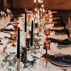 a long table is set with candles and place settings for an elegant dinner or party