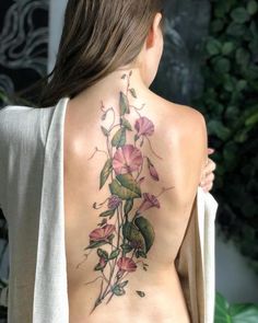 the back of a woman's body with flowers on it