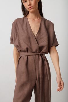 "AURORA is a short sleeve jumpsuit with belt. DETAILS - Wrap style top - Dolman sleeves - Self tie belt - Zip closure at the back - 100% lightweight European linen fabric - Cut and sewn to order just for you in our studio COLOR - Cocoa, you can also choose other colors above - Fabric samples are available here https://www.etsy.com/listing/586569696/linen-fabric-samples SIZING & FIT - Fits true to size - Model is 5'9.5\" / 177cm and wearing a size S CARE FOR LINEN - Machine wash up to 30ºC/86ºF gentle cycle - Lay flat to dry or tumble dry low - Warm iron if needed - Do not bleach SIZE GUIDE Size conversion guide Size XS (US 0-2, IT 36-38, UK 4-6, Japan 3-5, France 32-34) Size S (US 4-6, IT 40-42, UK 8-10, Japan 7-9, France 36-38) Size M (US 8-10, IT 44-46, UK 12-14, Japan 11-13, France 40-4 Linen Jumpsuits For Women, Belted Short Sleeve Jumpsuits For Work, Short Sleeve Belted Jumpsuits And Rompers For Work, Belted Short Sleeve Jumpsuits And Rompers For Work, Summer Wrap Jumpsuits And Rompers With Tie Waist, Fitted Short Sleeve Jumpsuits And Rompers With Tie Waist, Fitted Short Sleeve Jumpsuit With Tie Waist, Brown Short Sleeve Jumpsuits For Work, Brown Short Sleeve Jumpsuits And Rompers For Spring