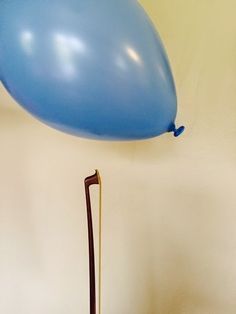 a blue balloon is being blown by a stick