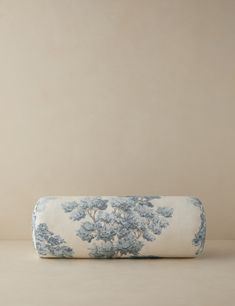 a blue and white pillow sitting on top of a table