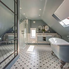 a bath room with a tub a sink and a mirror