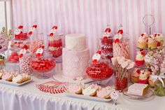 a table topped with lots of candy and cakes