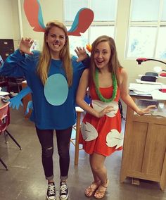 two girls are dressed up as bugs and grasshoppers in an office setting, one is wearing a costume