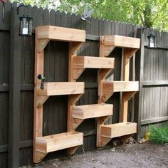 a wooden shelf sitting on top of a fence