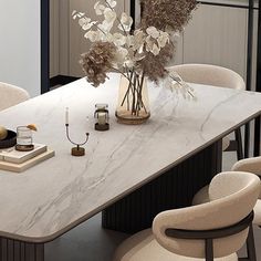 a dining room table with chairs and a vase filled with flowers on top of it