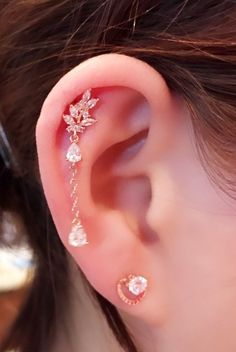 a woman's ear is shown with three different types of piercings