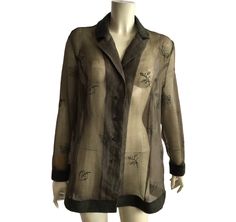 Gorgeous vintage sheer embroidered shirt in khaki color . The collar , cuffs and the end of the shirt are made from wool . Labeled as GB 20, IT 52, D 46 , fits like XL , but looks great oversize for smaller sizes . Chest 118 cm / 46 inches, length 76 cm / 29,9 inches . Material tag is missing . Perfect condition Sheer Long Sleeve Shirt For Work, Formal Long Sleeve Sheer Shirt, Sheer Long Sleeve Formal Shirt, Sheer Button-up Top For Fall, Summer Button-up Top With Sheer Sleeves, Spring Collared Top With Sheer Sleeves, Elegant Long Sleeve Shirt With Floral Embroidery, Elegant Button-up Tops With Sheer Sleeves, Sheer Long Sleeve Shirt For Fall