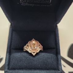 an engagement ring in a velvet box with the lid open to show it's inside