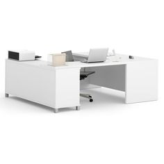 an office desk with a laptop on it