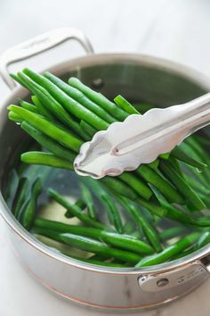 green beans being cooked in a pot with the title how to blancch green beans