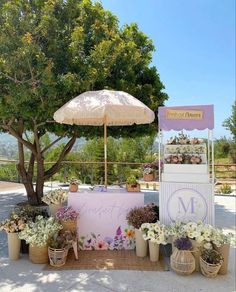 a table with flowers and an umbrella on it