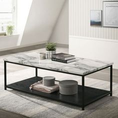 a marble coffee table with black metal frame and shelf on top in a living room