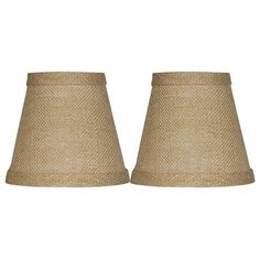 a pair of lampshades made out of jute and burluck fabric