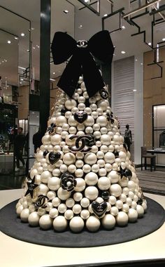 a christmas tree made out of balls and black bows