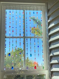 an open window with beads hanging from it