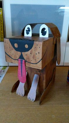 a cardboard dog sitting on top of a wooden table