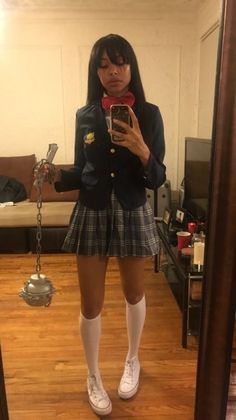 a woman taking a selfie in front of a mirror with her cell phone and socks on