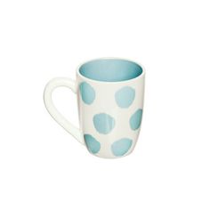 a blue and white polka dot coffee cup on a white background, with the bottom half painted off