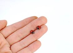 so cute and so realistic!tiny ladybug stud earringsjust the size of the real ladybugsterling silver post and a closure, a copper bug, coated with enamel (both sides, so the earring is non allergic)red enamel gets the most vibrant shade when combined with coppereach bug is hand painted with a tiny brush, each pair of earrings is unique Funky Stud Earrings, Ladybug Earring, Blueberry Emoji, Insect Earrings, Unique Stud Earrings, Ladybug Earrings, Ladybug Jewelry, Dope Jewelry Accessories, Unique Studs