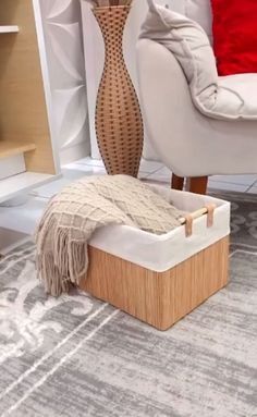 a living room with a white couch and a brown vase on the floor next to it