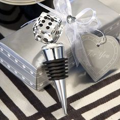 a dice shaped bottle stopper sitting on top of a table next to a box