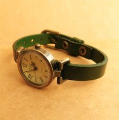 Adjustable Green Analog Watch, Green Watches With Leather Strap And Round Dial, Classic Green Watch For Everyday Use, Everyday Green Quartz Watch, Green Analog Watch As A Gift, Classic Green Watch With Leather Strap, Green Watch With Metal Dial As Gift, Green Watch With Metal Dial For Gift, Classic Green Watch Accessories For Everyday Use