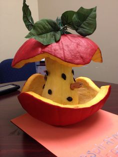 a fruit sculpture made to look like an apple with a piece of fruit in it