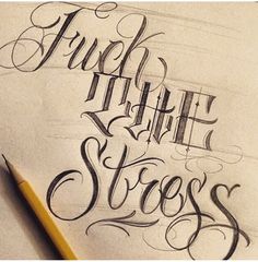 some type of lettering that is on top of a piece of paper with a pencil