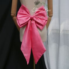 a mannequin with a pink bow on it's back