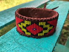 This design is inspired by traditional and contemporary Native American designs. It was handmade on a loom by Pedro with traditional size 11 seed beads and then hand sewn on soft chocolate deerskin leather. Red, light olive green, black, cobalt blue. Beautiful for men and women.  Closes with an Apple Jade stone.  1.25" x 8", adjustable for larger wrists You may also like this cuff: https://www.etsy.com/listing/835058668/diamond-diamond-eye-center-mens-tribal Handmade Traditional Brown Bracelets, Traditional Brown Bracelets For Festival, Traditional Brown Beaded Bracelets For Festival, Traditional Handmade Brown Beaded Bracelets, Traditional Beaded Bracelets As Gift, Traditional Adjustable Beaded Bracelets With Weaving, Traditional Beaded Bracelet As Gift, Traditional Handmade Brown Cuff Bracelet, Traditional Handmade Wristband For Festivals