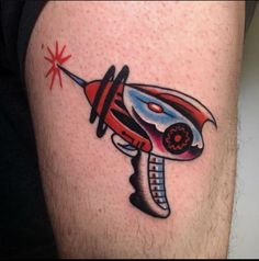 a tattoo on the leg of a man with a red and blue hair dryer