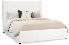 a white bed with two pillows on top of the headboard and foot board is shown