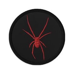 a red spider embroidered on a black patch