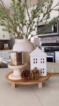 a small white house sitting on top of a wooden tray