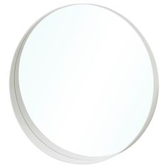 a white round mirror on the wall