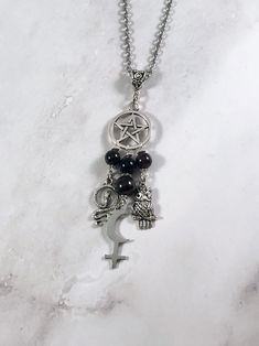 This beautiful chain necklace is the perfect way to express your affinity for Lilith. Charms: Snake Astrological Symbol Owl 3 garnet beads and one onyx bead also make up the pendant. Your choice of top charm: Pentacle, Chandelier, or Triple Moon Available in a variety of lengths. Secured with a lobster clasp. Chain is stainless steel. Charms are zinc alloy. All materials are lead and nickel free. Comes in a jewelry box so it's ready to be given as a gift. Have a idea for a custom order? I'd love Spiritual Black Dangle Necklaces, Symbolic Black Necklace With Adjustable Chain, Spiritual Black Chain Necklaces, Black Spiritual Chain Necklace, Black Pendant Charm Necklace With Chain, Spiritual Black Chain Necklace, Black Gothic Charm Jewelry, Black Gothic Jewelry With Charms, Black Metal Pendant Charm Necklace