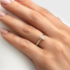 a woman's hand with a diamond ring on it