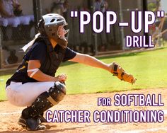 a softball player kneeling down to catch a ball