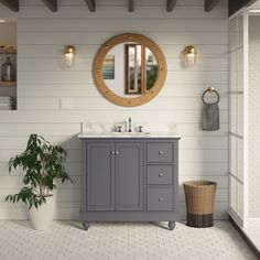 a bathroom with a sink, mirror and potted plant on the floor in front of it