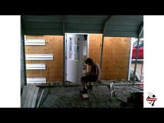 a man kneeling down in front of a white door