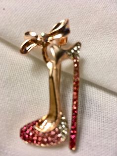 "This High Heel Shoe Brooch Pin, 50th Birthday Decor, 40th Birthday Decor, Paris Sweet 16 Theme, Paris 50th Birthday, Paris Decorations, Bridal Shower Gifts, Bridesmaid Gifts, 30th Birthday favors, High Heel Theme Birthday, High Heel Pin, High Heel Brooch, Rhinestone high Heel Brooch, Rhinestone High Heel Pin. This stunning Rhinestone Pin will dazzle your event. Great given as a gift, added to centerpieces, hats, coat, or outfit. This would be a stunning bridesmaid gift, or favor for a special b Gold Brooches With Rhinestones For Anniversary, Valentine's Day Party Brooch Jewelry, Gold Bling Brooches For Gift, Gold Bling Brooches Gift, Glamorous Rhinestones Brooches For Party, Glamorous Bling Brooches As A Gift, Glamorous Bling Brooches As Gift, Elegant Rose Gold Party Brooches, Gold Rhinestone Pins For Party