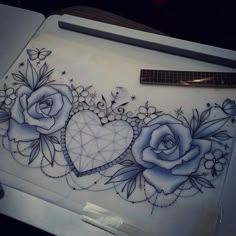 a drawing of two roses with hearts and diamonds on the back of a laptop computer