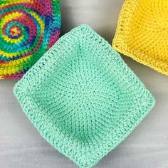 three crocheted dishcloths sitting next to each other