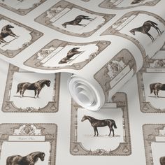 a wallpaper with horses and frames on it's sides, as well as a roll of tape