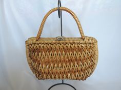 "Very fun handbag made of plastic coated woven wicker in a natural color featuring wicker wrapped handles and a gold tone twist clasp. The bag is lined in beige vinyl and features a very large open pocket. Label reads \"Bags by Donna\" Made in Taiwan\".  Measures 12 1/2\" Across, 7\" high and 4 1/2\" deep with a handle drop of 5\". Hardware is scratched, lining has some pen marks and small holes in the side gussets as shown in the last 3 photos. Great Condition" Fun Handbag, Vintage Clutch Purse, French Market Bag, Envelope Clutch Purse, Wicker Purse, Straw Clutch, Beaded Evening Bags, Woven Handbags, Straw Handbags