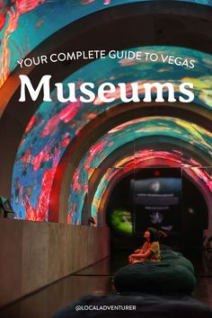 a woman sitting on a bean bag in front of a colorful tunnel with the words your complete guide to vegas museum's